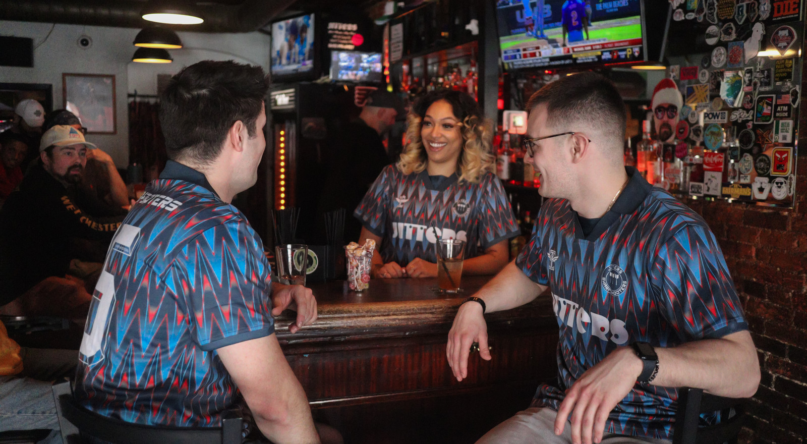 Friends in Jitters jerseys at the bar